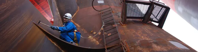 Work environment - surveyor climbing on a corroded installation